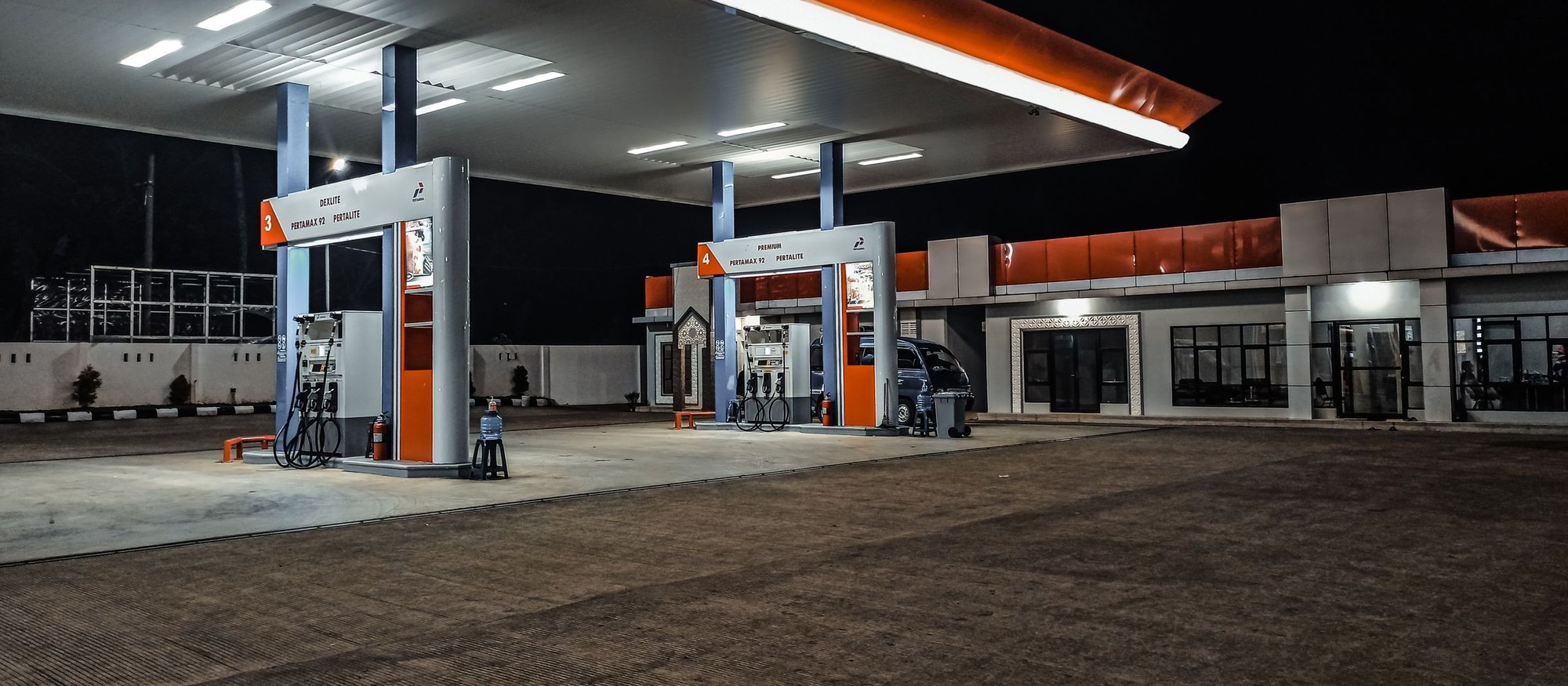 Fuel station forecourt lit at dusk